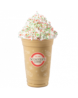 Blended Sugar Cookie Latte in clear Scooter's Coffee cup with whipped cream topped with red and green sprinkles