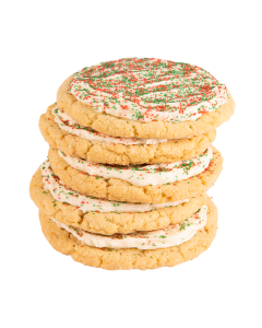 Stack of sugar cookies with white frosting topped with red and green sprinkles