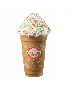 Iced Sugar Cookie Latte in clear Scooter's Coffee cup with whipped cream topped with red and green sprinkles