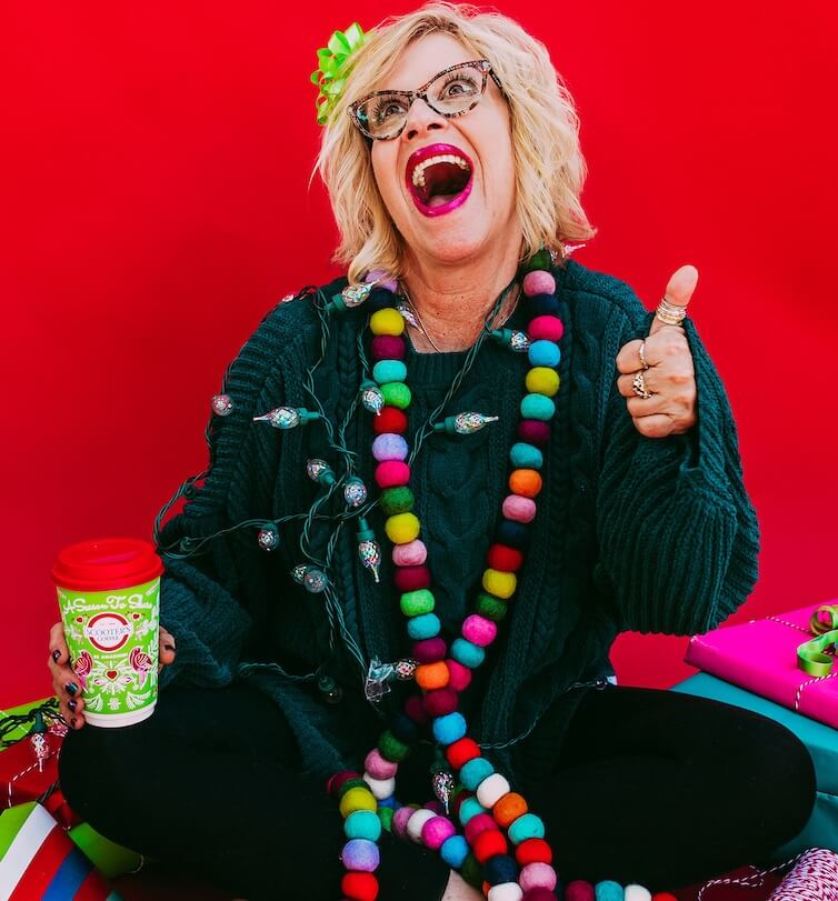 Woman with thumbs up and green coffee cup
