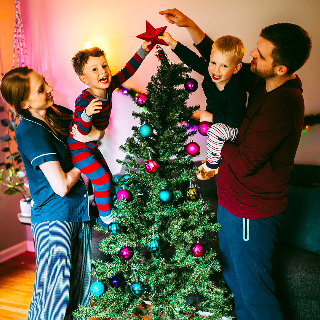 Family hanging star on tree