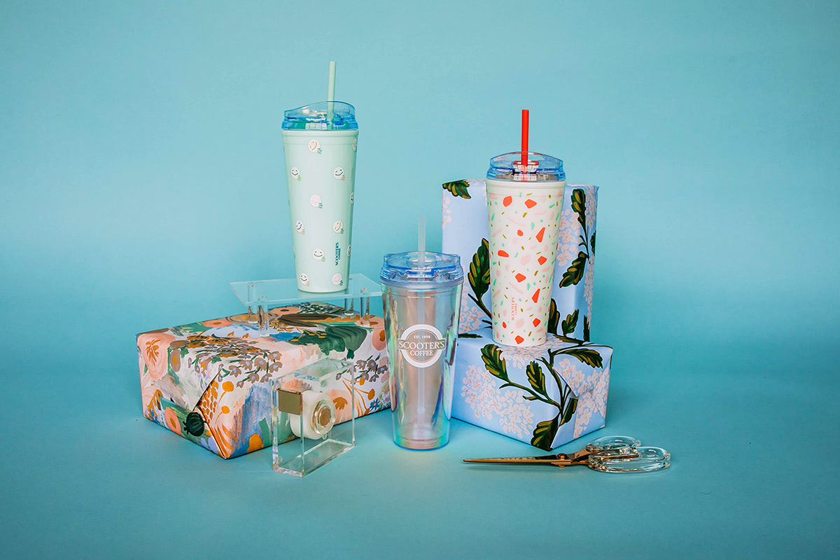 Tumblers next to wrapped gifts