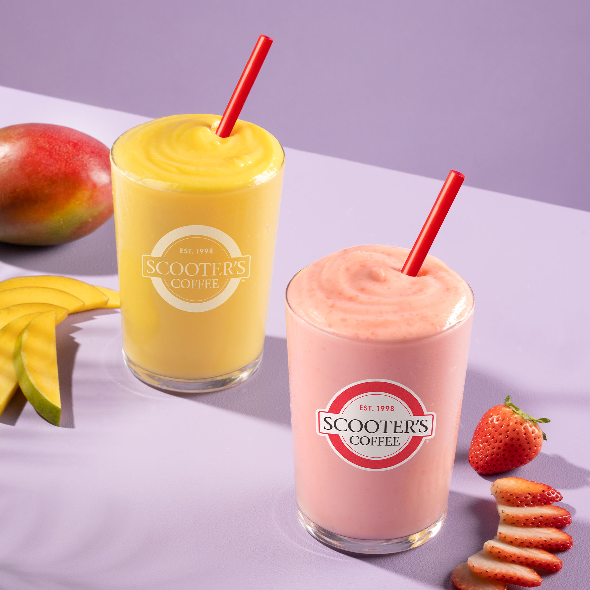 Red and yellow smoothies with red straw
